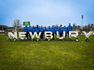 Cirka workers behind the Newbury sign