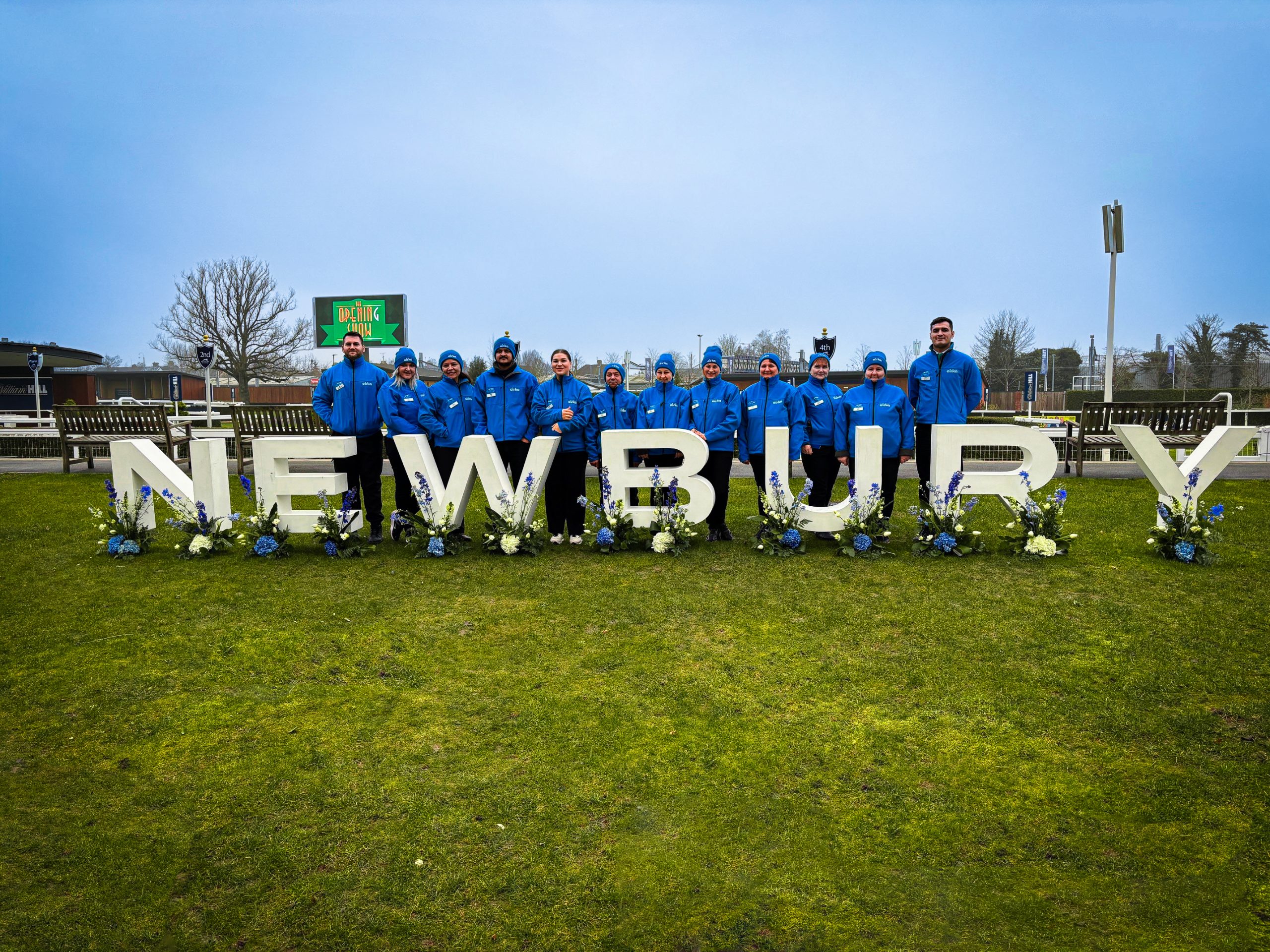 Cirka workers behind the Newbury sign